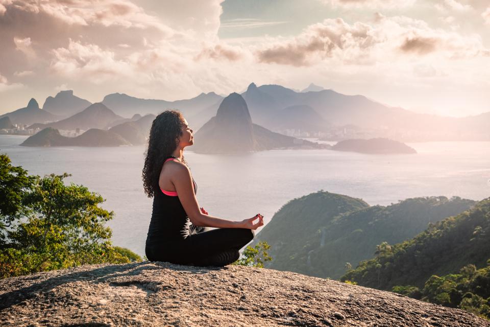 Woman Sat Meditating on a Hill
